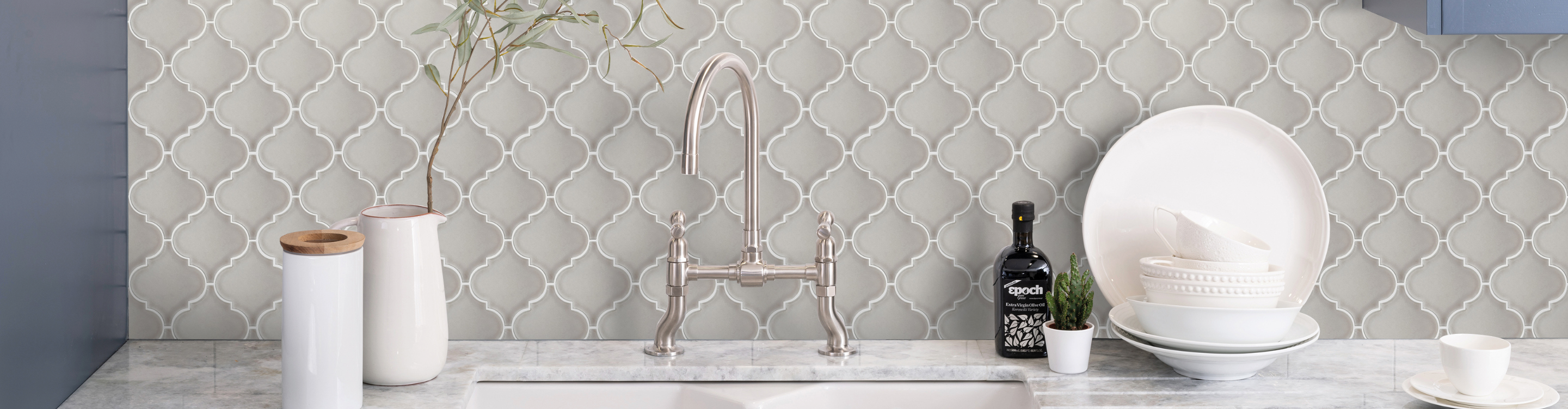 Grey tile backsplash behind sink. 